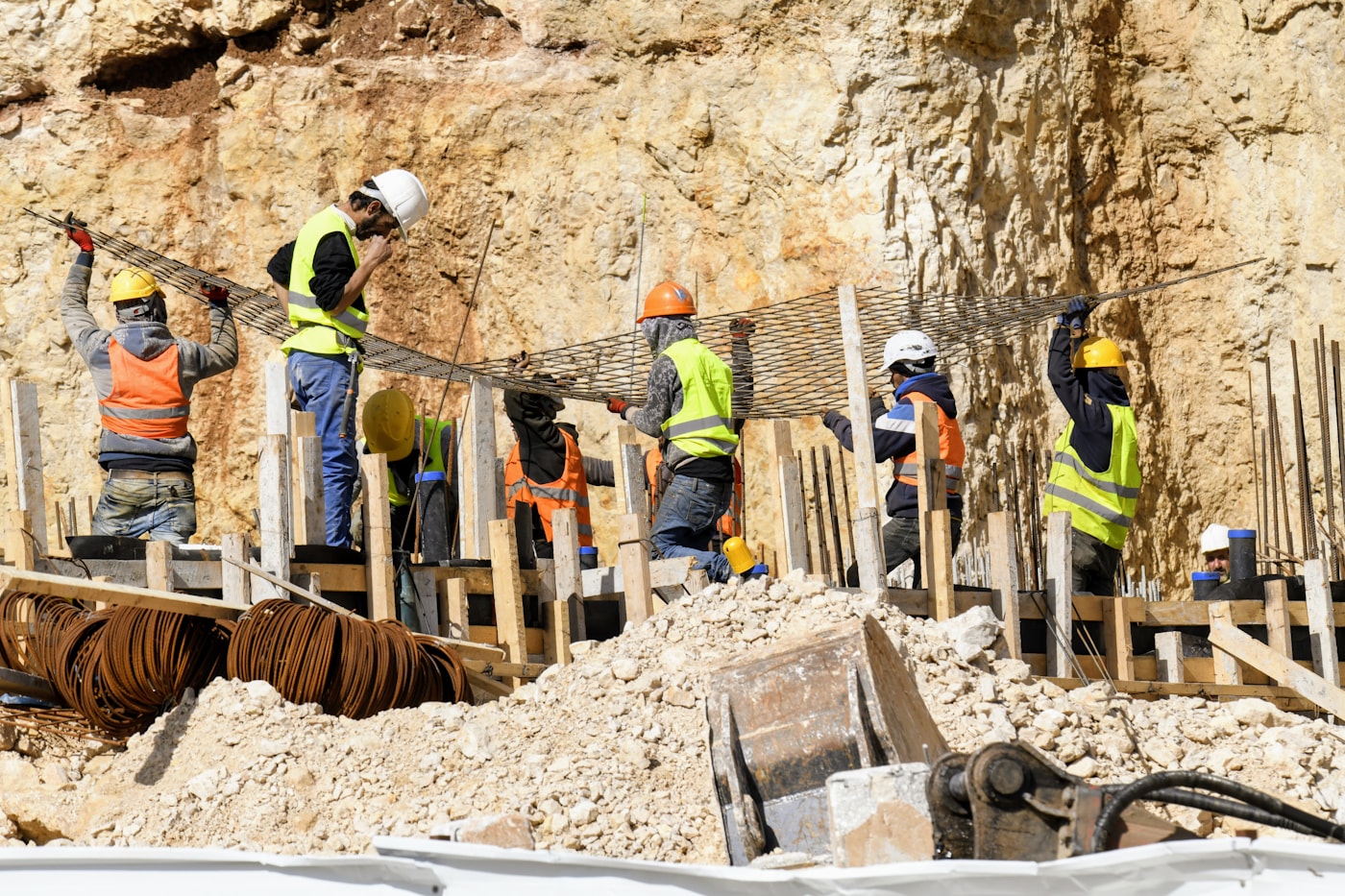 Active construction site with engineers reviewing digital plans