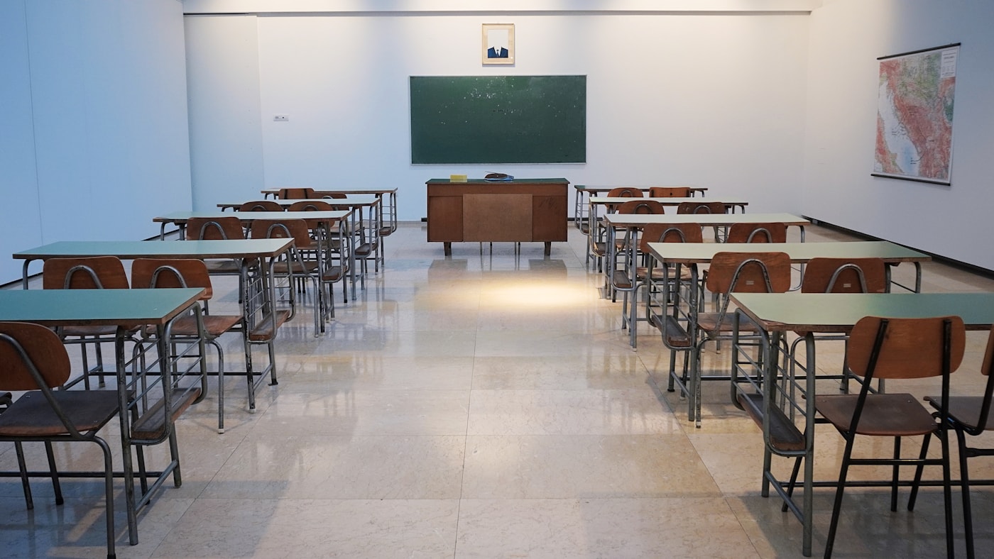 Students collaborating on laptops in a modern classroom — AI-powered learning in 2026