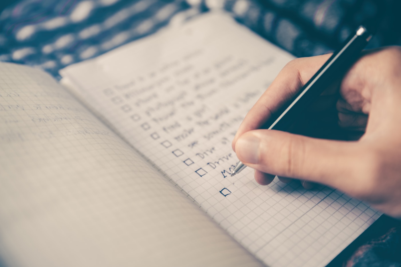 Student writing organized notes in a study checklist — the foundation of effective learning